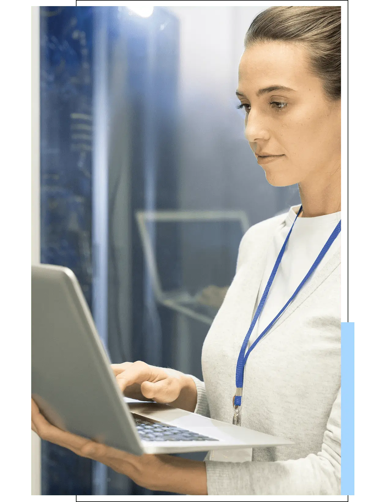 Woman using a tablet in a modern, glass-walled office.
